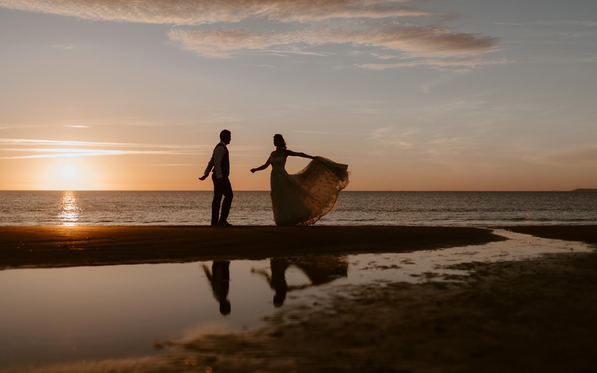 Séance couple après mariage mise en scène poétique et romantique sur la plage à Pornic au coucher de soleil par Geoffrey Arnoldy photographe