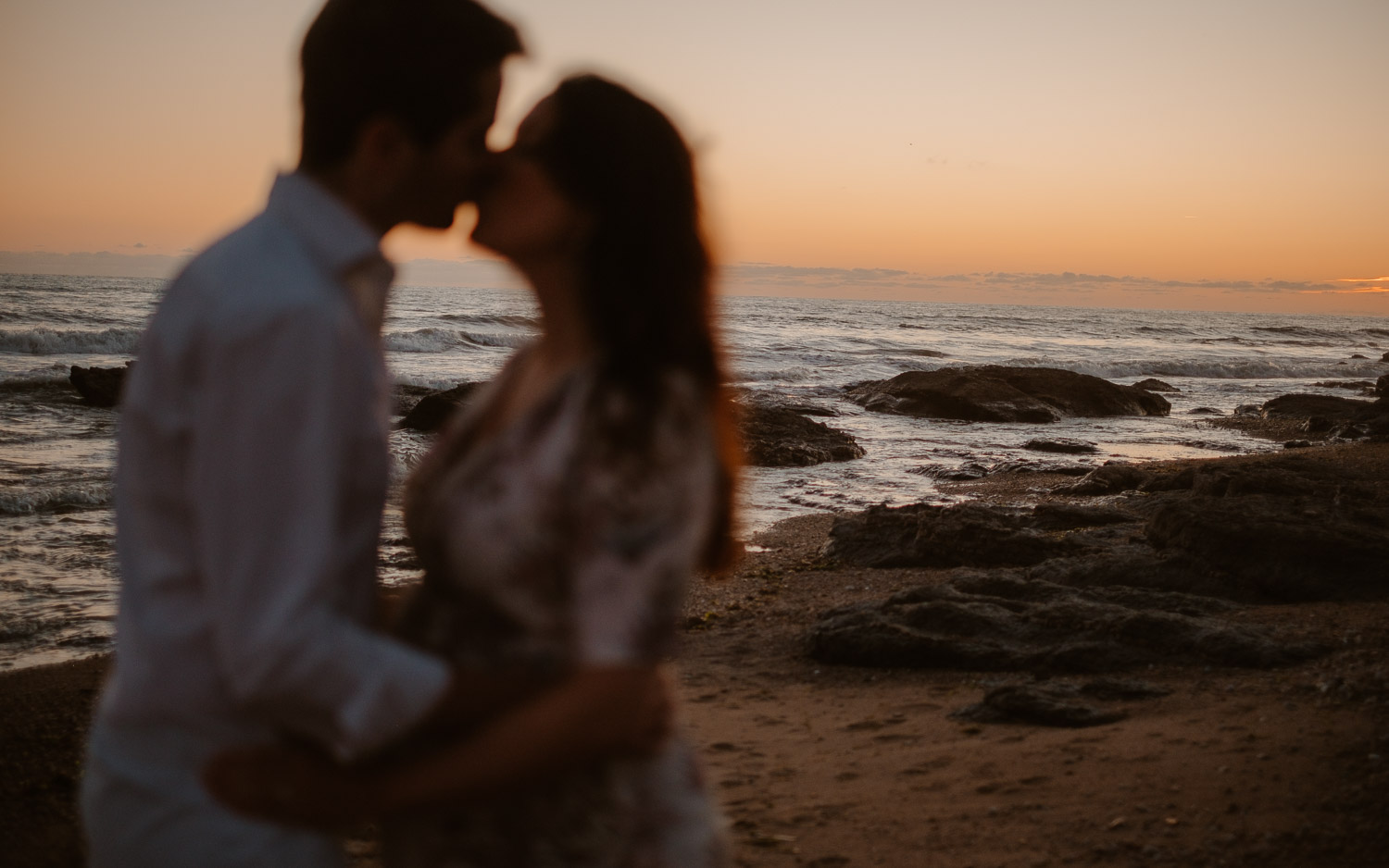 Séance photo en attendant bébé, ventre rond de futurs parents en extérieur, à l’ambiance romantique, au coucher de soleil sur la plage de Bretignolles-sur-mer en Vendée par Geoffrey Arnoldy photographe