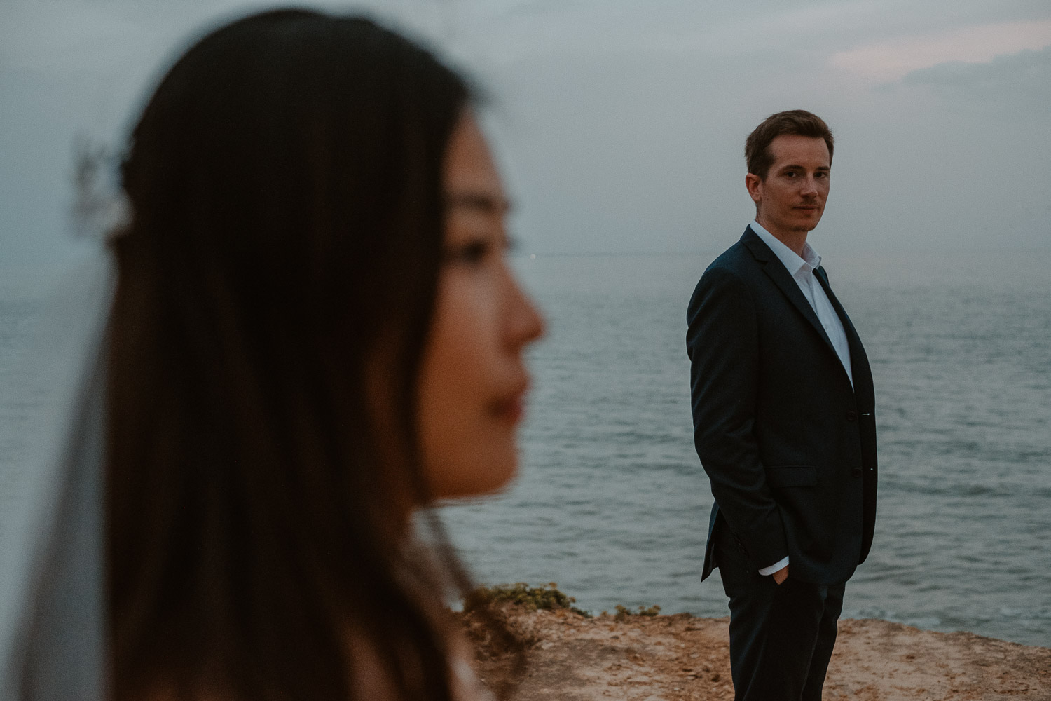 Photographie poétique au bord de l'océan d’un couple de mariés